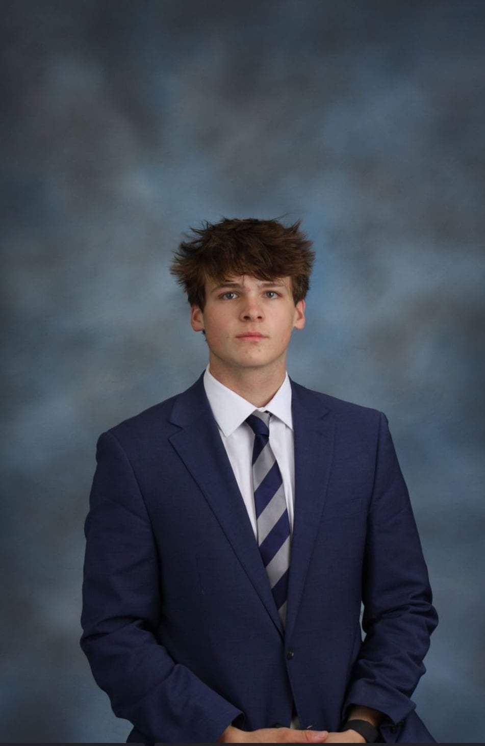 James Mills Paquin wearing a navy suit